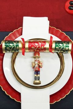 a nutcracker figurine sitting on top of a red and white plate