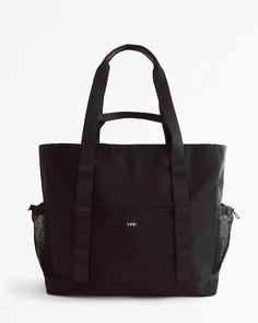 Our active tote bag with interior and exterior pockets throughout to hold your personal items and valuables. Includes top zipper closure, as well as a back trolley pass flap for easy use when traveling. Height: 15 in. Width: 5.5 in. Length: 18 in. Interior And Exterior, Bag Accessories, Mens Accessories, Personalized Items, Wallet, Tote Bag