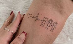 a woman's arm with a heartbeat tattoo on it