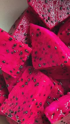 a white bowl filled with cut up pieces of watermelon and black dots on it