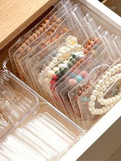 the drawers are filled with different types of beads