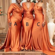 three women in orange dresses standing next to each other