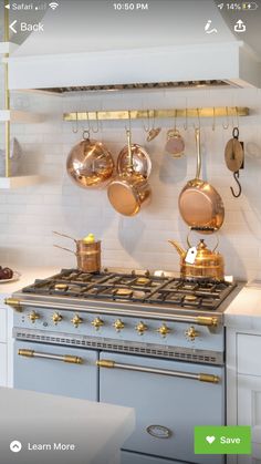 an appliance with pots and pans hanging on the wall next to a stove