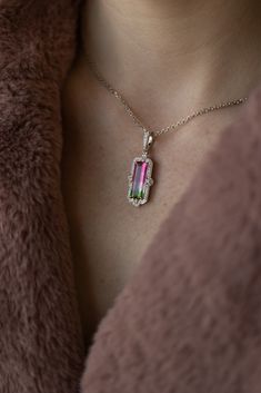 What a treat for the eyes! Wowza Watermelon Tourmaline Framed with Brilliant Diamonds is an extravagant pendant that contains one incredible natural watermelon tourmaline of 4.75 carats held by claw prongs in a regal shaped frame of brilliant white diamonds. The 18" diamond cut cable chain completes this look. 14k White gold 4.75ct Tourmaline .37ctw VS/F natural diamond accents Tourmaline White Gold Jewelry With Prong Setting, White Gold Tourmaline Jewelry With Prong Setting, White Gold Tourmaline Ring With Prong Setting, Luxury Tourmaline Pendant Jewelry, Luxury Tourmaline Jewelry With Prong Setting, Watermelon Jewelry, Watermelon Tourmaline Jewelry, Watermelon Tourmaline Necklace, Faberge Jewelry