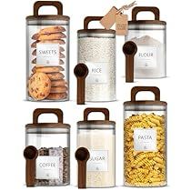 six glass canisters filled with cookies, crackers and other food items are shown