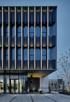 a large building with many windows and lights on the side of it's face