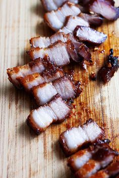 slices of bacon sitting on top of a wooden cutting board