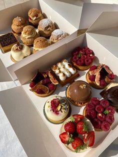 an open box filled with different types of pastries