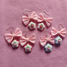 four pairs of pink bows with strawberrys and clouds are shown on a pink background