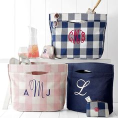 three bags with monogrammed designs on them are sitting next to each other and one has a straw in it