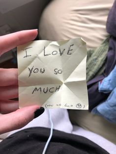 someone holding up a piece of paper that says i love you so much