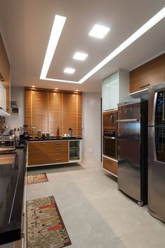 a modern kitchen with stainless steel appliances and wood cabinets