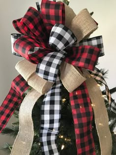 a christmas tree with a red and black plaid bow