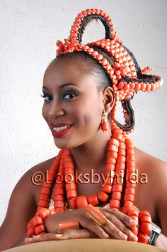 a woman with an orange necklace and some beads