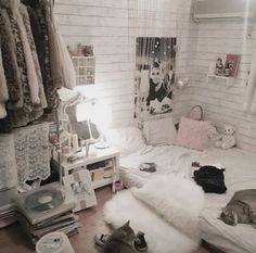 a bedroom with white brick walls and lots of stuff on the floor