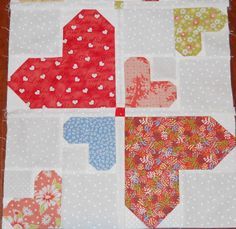 a close up of a piece of fabric on a wooden table with an arrow in the middle