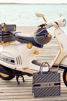 a white scooter parked on top of a wooden pier