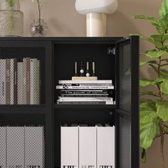 a black cabinet filled with lots of books