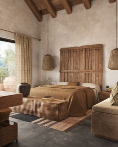 a bedroom with a large bed and wooden headboard on the wall next to a window