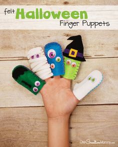 a hand holding five finger puppets in different colors and sizes with the words felt halloween finger puppets