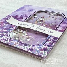 a purple card with white writing on it that says happy valentine's day and is filled with lots of tiny beads