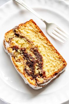 a piece of cake sitting on top of a white plate with a fork next to it