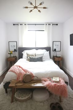 a bedroom with a white bed and pink fur rug