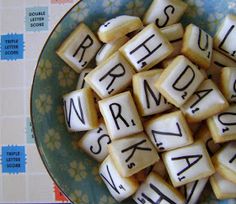 a bowl filled with diced letters sitting on top of a blue and white plate