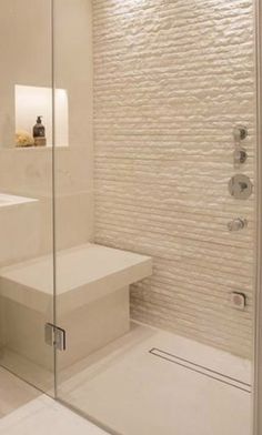 a bathroom with a glass shower door next to a sink