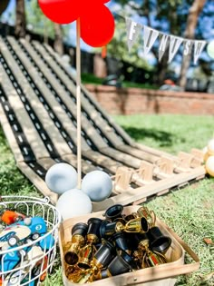 a basket filled with lots of toys on top of a grass covered field