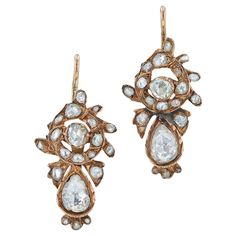 A pair of antique Georgian rose cut diamond earrings that ooze with history and beauty. Descending from floral rosettes adorned with 34 enchanting rose cut diamonds that dance in the light and dangle seductively with the pear shape teardrop diamonds at the bottom. These heirloom diamonds weigh an estimated 1.50 carats total, as the mountings permit. Set in period-proper foil back settings in 8 karat rose gold with a fabulous patina.   Condition: Good; wear consistent with age and use Era: Georgi Vintage Diamond Earrings, Teardrop Diamond, Pearl Engagement Ring, Earring Box, Bow Ring, Engagement Ring Diamond Cut, Gilded Age, Custom Earrings, Antique Earrings