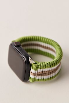 an apple watch strap is shown on a white surface with a green and brown stripe