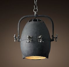 a light fixture hanging from a chain with an iron frame and metal fittings on it