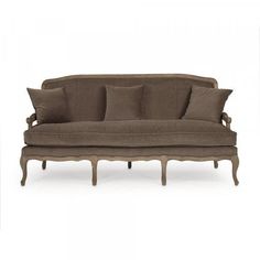 an old fashioned couch with pillows on the back and armrests, sitting against a white background