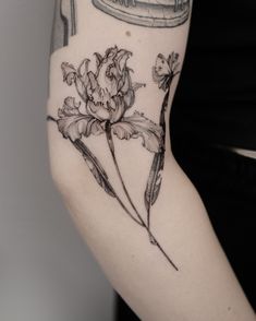 a woman's arm with flowers on it