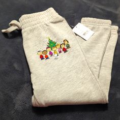 Brand New With Tags! Cute Holiday Theme Peanuts Gang Sweat Pants. Features The Whole Group Near A Christmas Tree On Left Pant Leg. Retails At $10. Christmas Sweat Pants, Casual Cotton Pants For Christmas, Christmas Cotton Bottoms With Elastic Waistband, Cute Winter Cotton Pants, Casual Cotton Bottoms With Cartoon Print, Casual Cotton Pants With Cartoon Print, Cute Cotton Pants For Winter, Casual Cartoon Print Pants For Loungewear, Cotton Lounge Pants With Cartoon Print