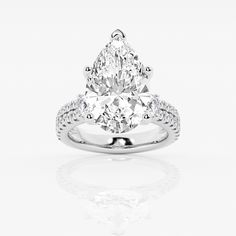 a pear shaped diamond engagement ring on a white background