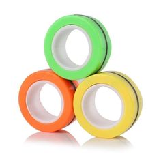 three rolls of colored tape sitting on top of each other in front of a white background