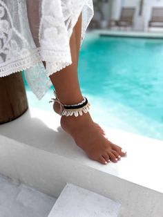 This exquisite Boho Cowrie Shell Ankle Bracelet is a summer essential for those who love a touch of the ocean in their style. Handcrafted meticulously, this anklet features authentic cowrie shells, symbolizing protection and strength, paired with fine beads that enhance its aesthetic appeal. Perfect for beach days or a casual sunny outing, this ankle bracelet embraces the spirit of summer with its natural, bohemian vibe. Its adjustable design ensures it fits comfortably around any ankle, making Ankle Strap Barefoot Sandals For Beach Season, Ankle Strap Barefoot Sandals For Beach Vacation, Summer Beach Anklet With Ankle Wrap, Summer Beach Anklets With Ankle Strap, Bohemian Friendship Bracelets For Beach Season, Beach Toe Ring Anklets, Summer Beach Toe Ring Anklet, White Ankle Wrap Anklets For Beach, White Bohemian Barefoot Sandals For Vacation