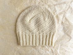 This hat is a snowy white (almost a cream) and super soft to the touch. It uses 100% recycled wool and feels like Merino. The hat has a ribbed brim and spiral up the top. It'll be a great neutral addition to a cold weather wardrobe. The yarn for this hat was recycled from a wool sweater, and was purchased at a local crafts supply thrift store before being knit by hand and then washed in a smoke-free environment. This hat is suitable for all gender and sized for an adult. Enjoy! The hat will arri Compostable Packaging, Slouchy Hat, Local Crafts, Wool Sweaters, Cold Weather, Caps Hats, Accessories Hats, Color Palette, Recycling