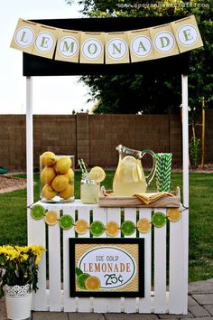 an outdoor lemonade stand is set up in the yard