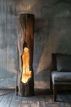 a lamp that is sitting on top of a wooden tree stump in the middle of a room