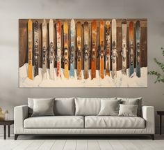 a living room with a couch and painting on the wall above it that has skis painted on it