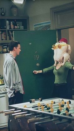 a man standing in front of a board with a stuffed animal on it's back