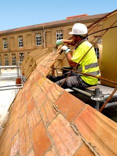 a construction worker working on the roof of a building