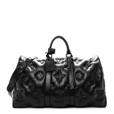 This is an authentic LOUIS VUITTON Lambskin Monogram Keepall Puffer XL Bandouliere 75 in Black. This stylish travel duffel is crafted of signature Louis Vuitton monogram lambskin in black. This bag features rolled top handles, an optional adjustable shoulder strap, and matte black hardware. The top zippers open to a spacious black fabric interior with a pocket. Louis Vuitton Puffer Bag, Louis Vuitton Duffle Bag Travel, Designer Duffel Bag, Designer Bags Men, Lv Men Bag, Louis Vuitton Luggage Set, Louis Vuitton Duffel Bag, Luxury Bag Men, Elizabeth Windsor