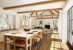 a large kitchen with an island in the middle and lots of counter space on one side