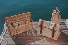 two wicker baskets and wine glasses on a dock