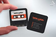 a hand holding a business card with an old school cassette label on it and the words leann grubs next to it