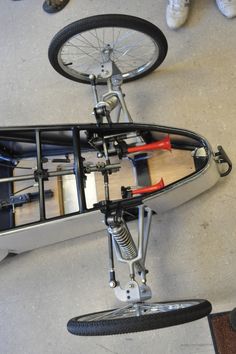 an upside down view of a bike with a rear wheel